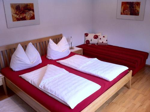 a bedroom with two beds with red and white pillows at Apartment Bachmann in Bludenz