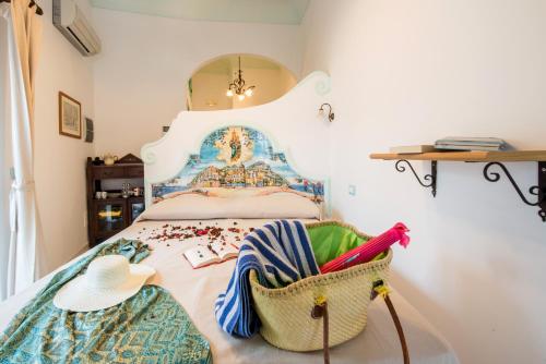 a bedroom with a bed with a basket on it at Ricciolo d'oro 1 in Positano