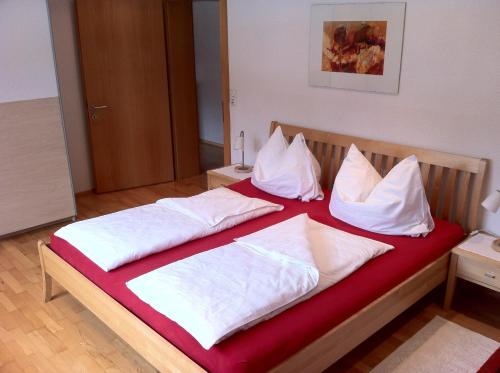a bedroom with two beds with white pillows at Apartment Bachmann in Bludenz