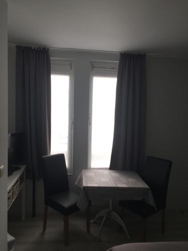 
a table and chairs in a small room at Hotel Chaplin in Blankenberge
