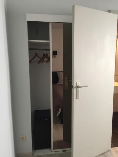 
a door is open to a room with a white door at Hotel Chaplin in Blankenberge
