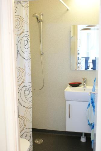 a bathroom with a shower and a sink at Læsø Camping & Hytteby in Vesterø Havn