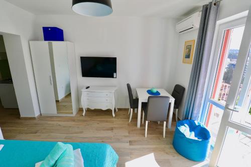 a living room with a blue couch and a table at Meridiens in Dubrovnik