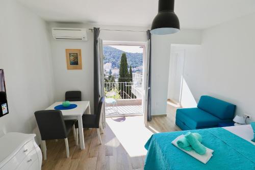 a room with a bed and a table and a chair at Meridiens in Dubrovnik
