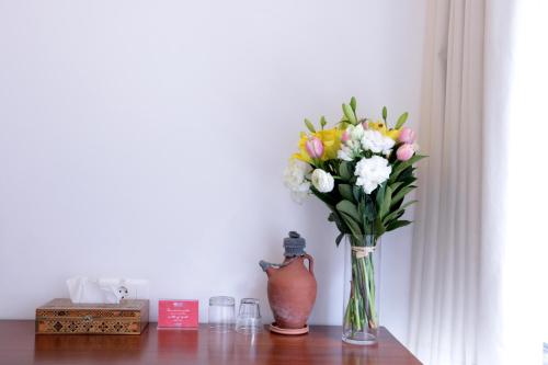 a vase of flowers sitting on a table at Hamra Urban Gardens in Beirut