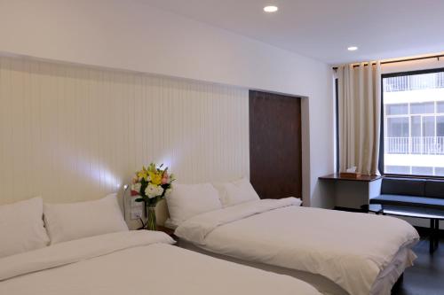 a hotel room with two beds and a piano at Hamra Urban Gardens in Beirut