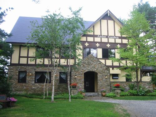 a large stone building with a sign on it at Anise Garden in Hakuba