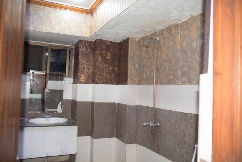 a bathroom with a sink and a shower at Premier Inn Davis Road Lahore in Lahore