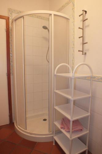 a shower in a bathroom with white shelves at Le Soleil in Campo nell'Elba