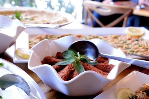 a white bowl filled with food on a table at Hamra Urban Gardens in Beirut