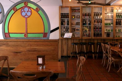 a room with tables and chairs and a stained glass window at Hamra Urban Gardens in Beirut