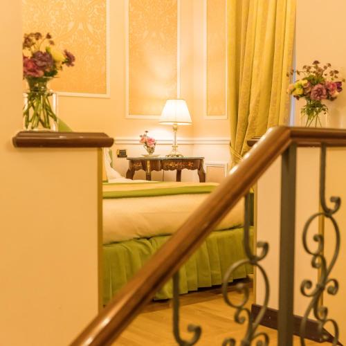 a hotel room with a bed with flowers on it at Hotel Bernini Palace in Florence