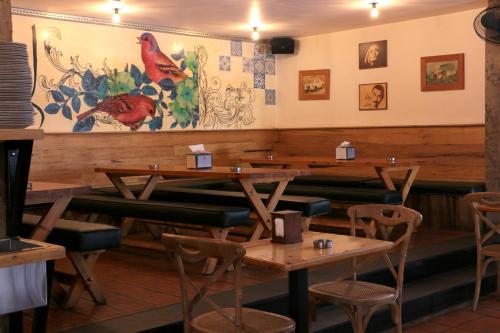 a dining room with wooden tables and chairs at Hamra Urban Gardens in Beirut