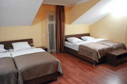 a hotel room with two beds in a room at Hotel Toni in Gudauri
