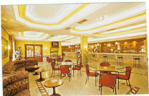 a hotel lobby with tables and chairs and a bar at Hotel Perú by Bossh! Hotels in Trujillo