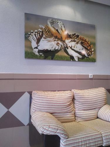 a couch in a room with two paintings on the wall at Hotel Perú by Bossh! Hotels in Trujillo