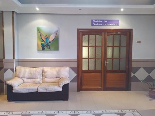 a waiting room with a couch and a door at Hotel Perú by Bossh! Hotels in Trujillo