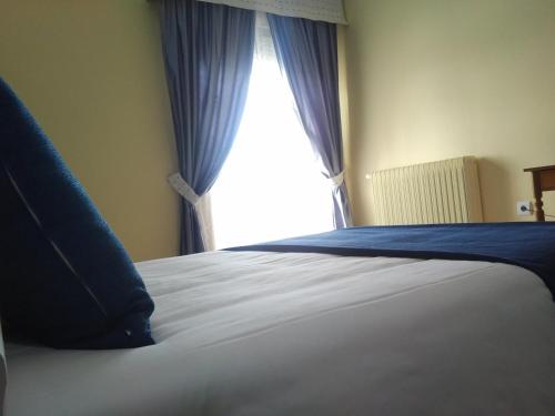 a close up of a bed with a window at Hotel Perú by Bossh! Hotels in Trujillo
