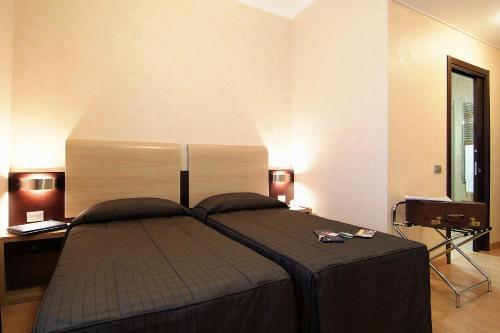 a bedroom with a large bed with a large headboard at EH Rome Airport Euro House Hotels in Fiumicino