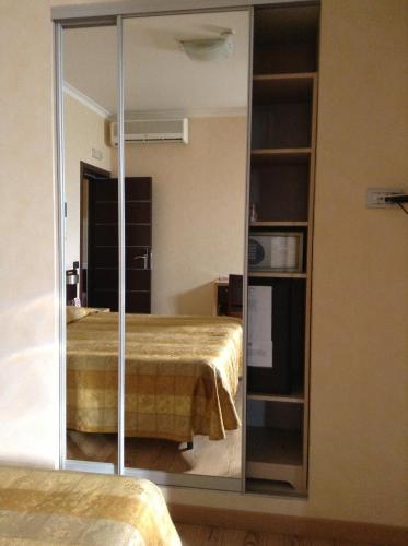 a mirror in front of a room with a bed at EH Rome Airport Euro House Hotels in Fiumicino