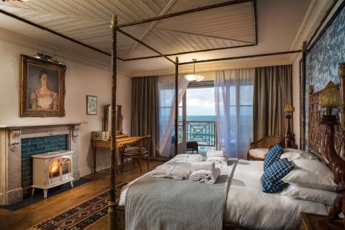 a hotel room with a bed and a fireplace at Tolcarne Beach Colonial Restaurant and Rooms in Newquay