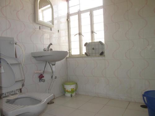 a bathroom with a sink and a toilet at Ashish Marriage Place in Jaipur