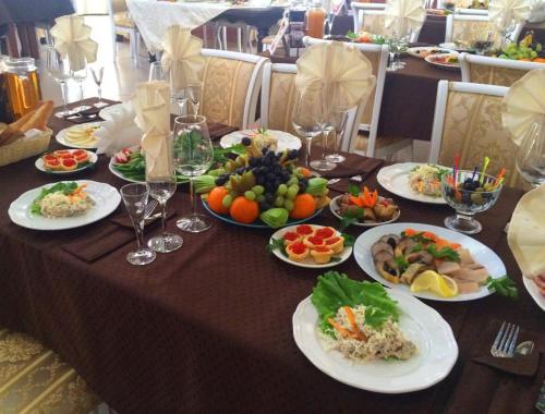 a table with plates of food on top at Hotel Ternopol in Zelenodolsk