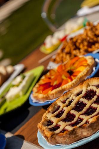 a table with three plates of food on it at Tenuta Petra Bianca in Palau