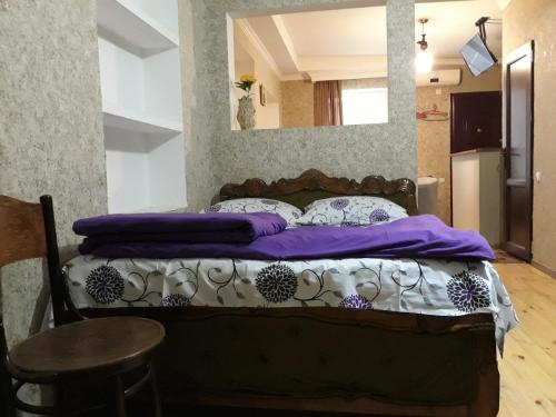 a bedroom with a bed with a mirror on the wall at Rati apartments in Tbilisi City
