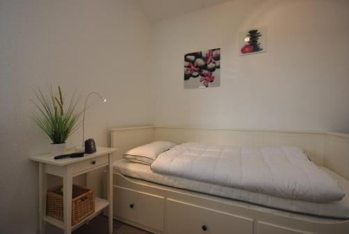 En eller flere senge i et værelse på FeWo Altenau