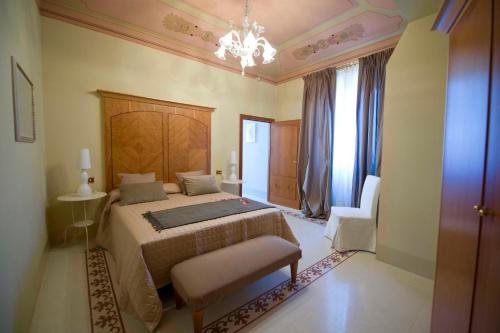 a bedroom with a bed and a chandelier at Modà Antica Dimora in San Marino