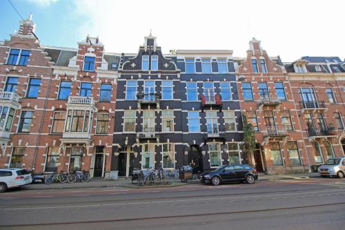 a large building with blue windows on a city street at Vondelpark Suite in Amsterdam