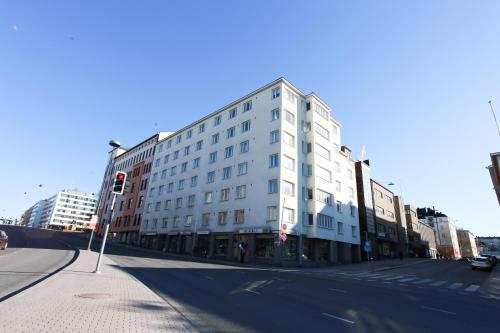 a white building on a city street with a traffic light at Studio apartment in central Turku in Turku