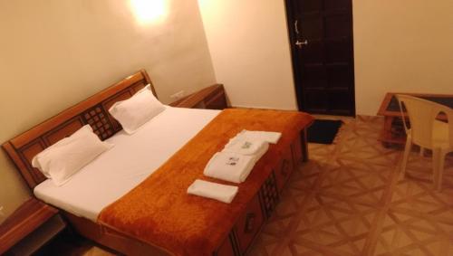 a bedroom with a bed with two towels on it at Rann Resort Dholavira in Dholovira