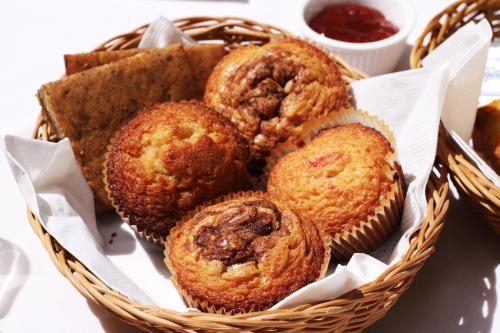 a basket filled with muffins sitting on a table at Viva Merida Hotel Boutique in Mérida