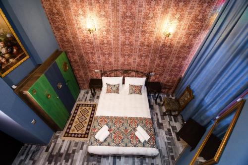 a bedroom with a bed in a blue room at Tiflis Inn Boutique Hotel in Tbilisi City