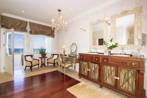 a bathroom with a sink and a desk with a mirror at Villa Mila in Puerto Calero