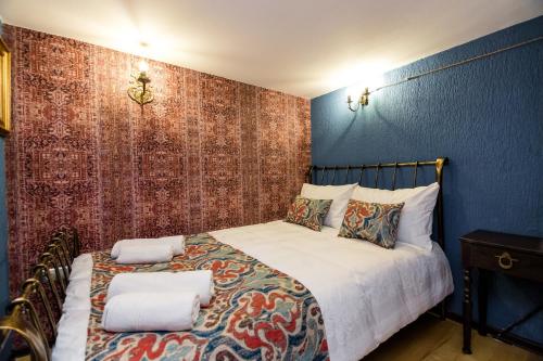 a bedroom with a bed with two pillows on it at Tiflis Inn Boutique Hotel in Tbilisi City