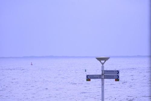 a street sign in front of a body of water at Planke 18 in Norderney