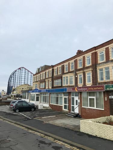 an empty parking lot in front of a building at Sandpiper Holiday Apartments in Blackpool
