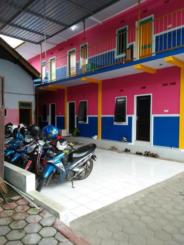 a group of motorcycles parked in front of a building at Homestay Lidiya in Banyuwangi