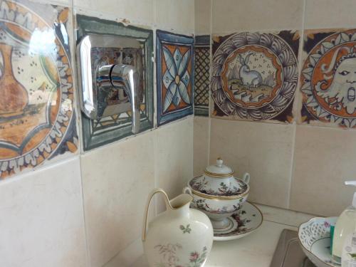 a room with a tea pot and plates on the wall at Genius Loci Country Inn in Bevagna