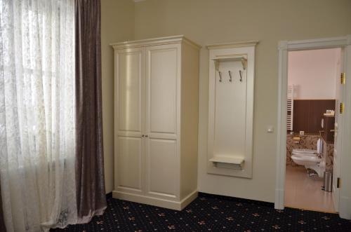 a bathroom with a toilet and a sink at Chateau Royal Hotel in Berezovka