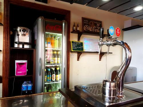 a refrigerator freezer sitting next to a kitchen counter at Hotel le Trianon in Antsirabe