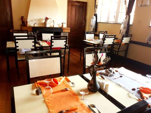a dining room with tables and chairs with vases on them at Hotel le Trianon in Antsirabe