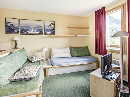 Il comprend un salon doté d'un canapé et d'une télévision. dans l'établissement Residence Les Constellations - maeva Home, à Belle Plagne