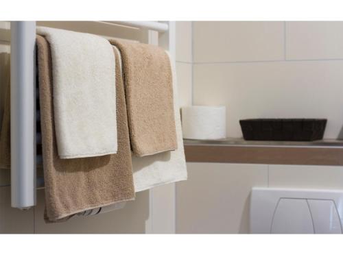 a bathroom with towels hanging on a towel rack at Pension Möser in Lennestadt