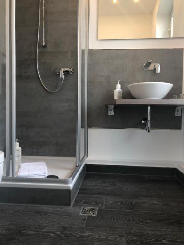 a bathroom with a sink and a shower at Hotel Bedburger Mühle in Bedburg