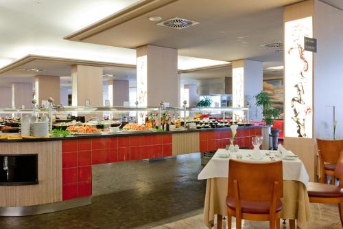 a restaurant with a buffet line of food at Adrián Hoteles Roca Nivaria in Adeje