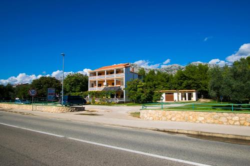 a building on the side of a road at Apartmani Vesna in Starigrad-Paklenica